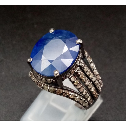 628 - An 8.70ct Blue Sapphire Ring - with 1.55ct of Diamond Accents. Set in 925 Silver. Size M. 7.3g total... 