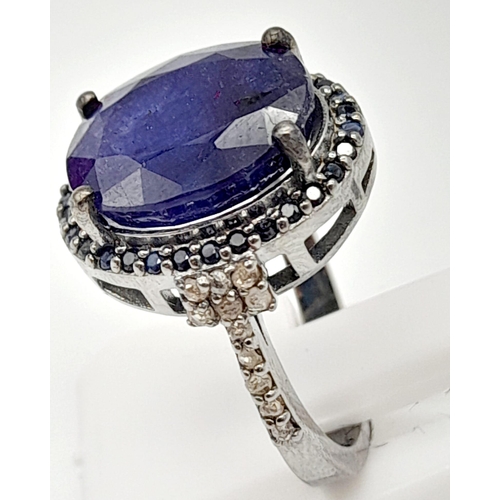 35 - A 7.50ct Blue Sapphire Gemstone Ring with 0.30ct diamond wings and 0.60ct blue sapphire surround. Si... 