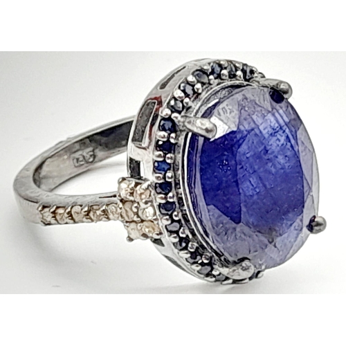 35 - A 7.50ct Blue Sapphire Gemstone Ring with 0.30ct diamond wings and 0.60ct blue sapphire surround. Si... 