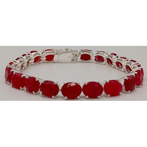 633 - A Ruby Gemstone Tennis Bracelet set in 925 Silver. 20 oval cut rubies. 19cm. 21g total weight.