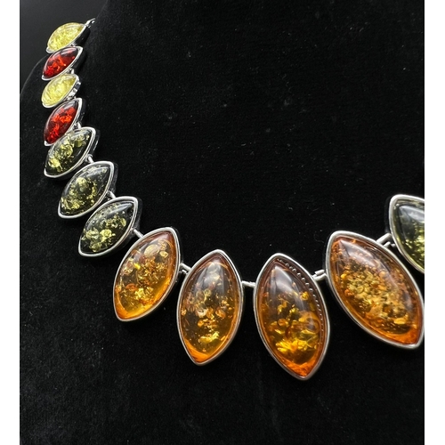 175 - A very attractive, multi-colour, amber necklace, earrings and ring set in a presentation case. Neckl... 