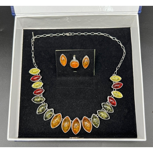 175 - A very attractive, multi-colour, amber necklace, earrings and ring set in a presentation case. Neckl... 