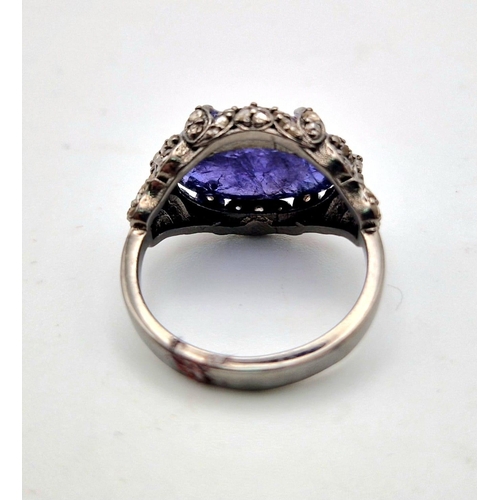 30 - An Art Deco Style 7.30ct Tanzanite Gemstone Ring with 0.65ct Diamond Accents. Set in 925 Silver. Siz... 