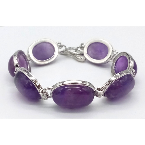 427 - An Amethyst Brooch, Bracelet and Pair of Earring Set. Bracelet - 18cm. Brooch - 5cm and 4cm earring ... 