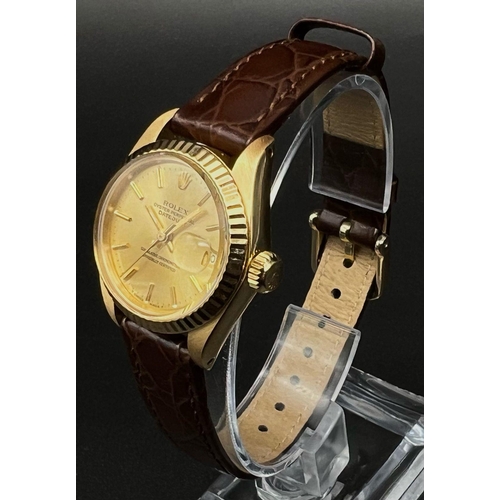 287 - A LADIES 18K GOLD ROLEX OYSTER PERPETUAL DATEJUST WRIST WATCH, WITH GOLD TONE DIAL ON BROWN LEATHER ... 