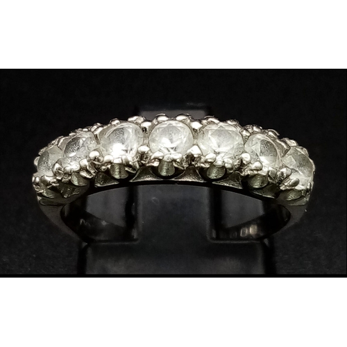 587 - An 18K White Gold White Stone Half Eternity Ring. Size K. 3g total weight.