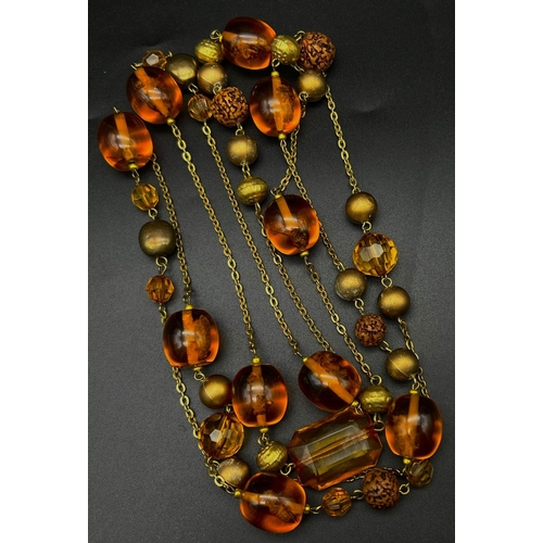 741 - Am Amber-Coloured Resin Rope-Length Insect Necklace. 150cm.