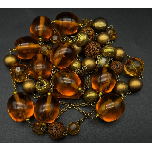 741 - Am Amber-Coloured Resin Rope-Length Insect Necklace. 150cm.