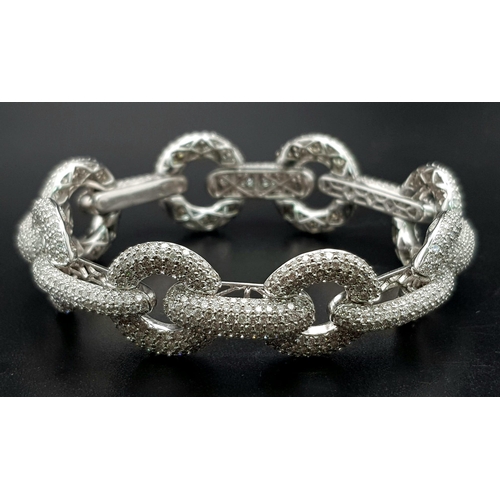 103 - A Head-Turning 18K White Gold 12ct Diamond Circle Bracelet. 1200 VVS/VS quality encrusted diamonds s... 