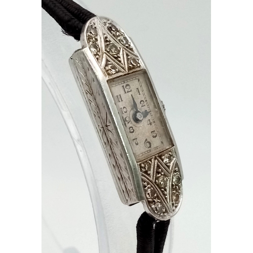 135 - A Vintage Art Deco Style Platinum and Diamond Ladies Watch. Rectangular case - 11 x 30mm. Rope-style... 