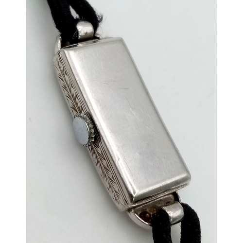 135 - A Vintage Art Deco Style Platinum and Diamond Ladies Watch. Rectangular case - 11 x 30mm. Rope-style... 