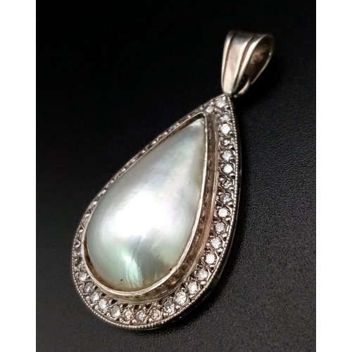 170 - A Vintage Teardrop South Sea Pearl and Diamond Pendant. Set in silver this beautiful pearl cabochon ... 