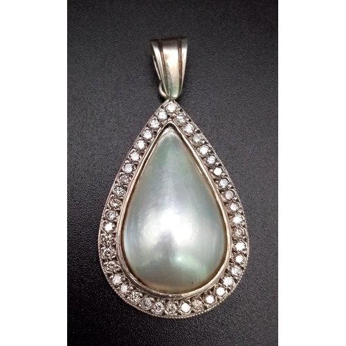 170 - A Vintage Teardrop South Sea Pearl and Diamond Pendant. Set in silver this beautiful pearl cabochon ... 