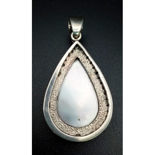 170 - A Vintage Teardrop South Sea Pearl and Diamond Pendant. Set in silver this beautiful pearl cabochon ... 