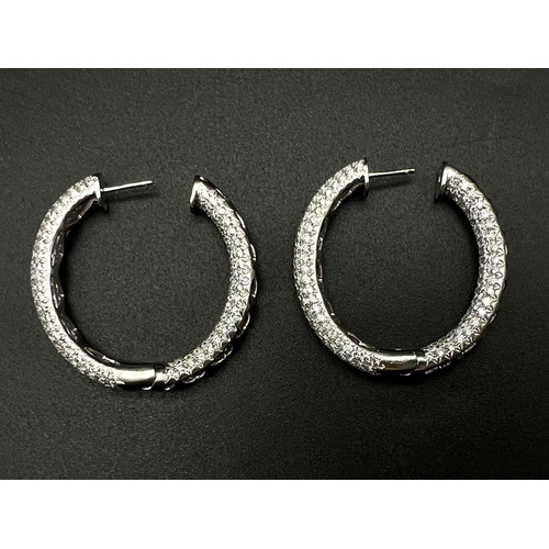 42 - A Pair of Elaborate 18K White Gold and Diamond Hoop Earrings. With over 500 VVS1 quality white diamo... 