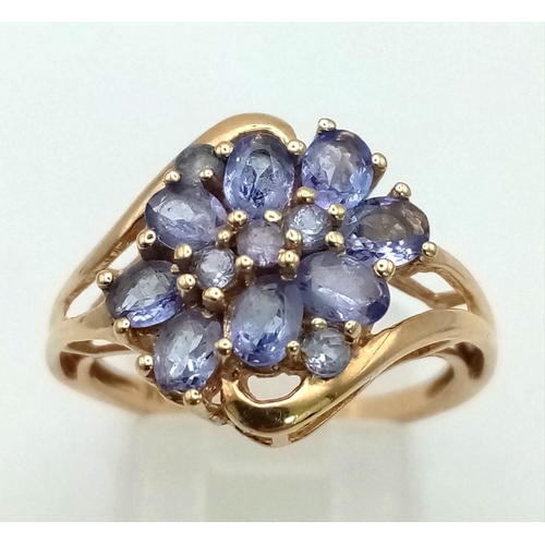 739 - A 9K Yellow Gold and Tanzanite Decorative Floral Ring. Size O. 3g total weight. Ref: 24