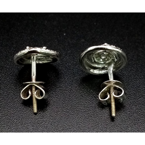 1186 - A Pair of 9K White Gold and Diamond Swirl-Stud Earrings. 1.67g total weight. Ref: 53