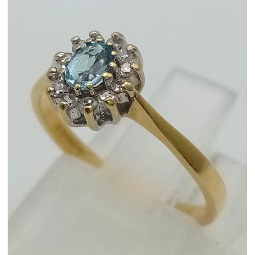 467 - An 18K Yellow Gold Aquamarine and Diamond Ring. Central aquamarine gemstone with a halo of diamonds.... 