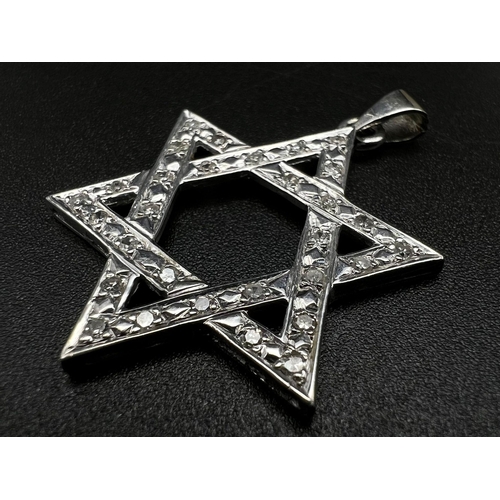 639 - An 18K White Gold and Diamond Star of David Pendant. 4cm. 4.23g. Ref:87