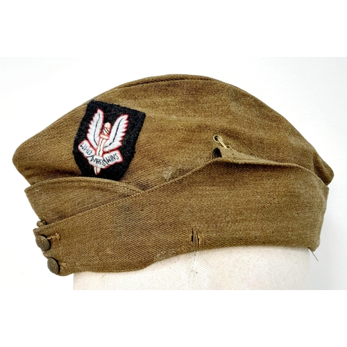 324 - WW2 British Army “Chip Bag” side cap with a cloth S.A.S cap badge.