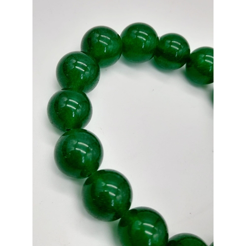 1123 - A Green Jade and a Tigers Eye, Obsidian and Hematite Expandable Bracelet. Jade -12mm. Others - 8mm.