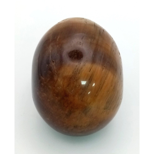 576 - A Hand-Carved Tigers Eye Skull Figure. Ornament or paperweight. 6cm