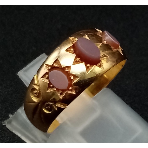 577 - A 15K Gold Matrix Carnelian Three Stone Band Ring. Hallmarks for Chester. Size N. 3.57g total weight... 