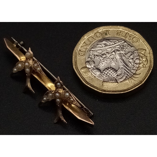 257 - A Victorian Mid-Karat Gold Swallow and Pearl Bar Brooch. Pin has been replaced. 4cm. 1.4g total weig... 