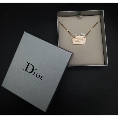 530 - A Christian Dior Gilded Tag Necklace. 42cm adjustable. Excellent condition. Comes in a Dior box. Ref... 