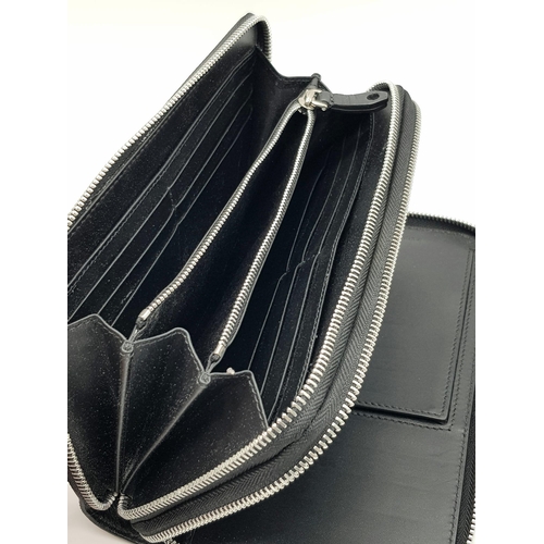 502 - A Burberry Black Leather Wallet Clutch Bag. Two zipped compartments - purse and a wallet. In very go... 