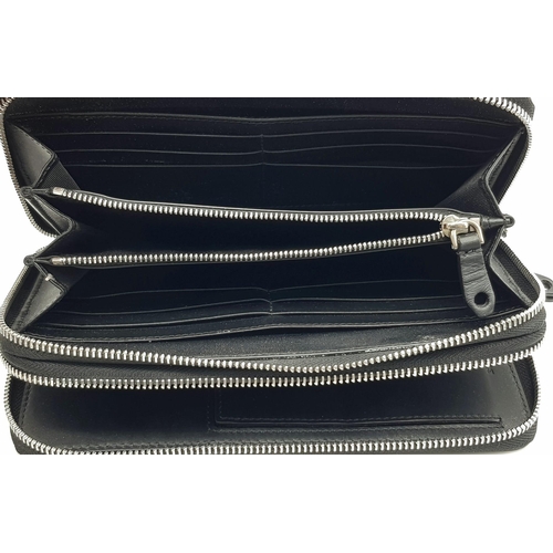 502 - A Burberry Black Leather Wallet Clutch Bag. Two zipped compartments - purse and a wallet. In very go... 