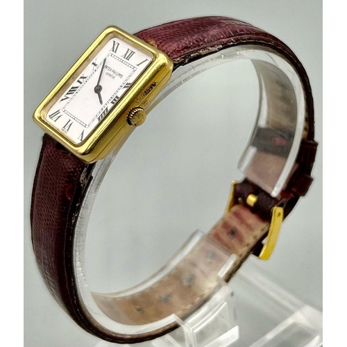 353 - A Classic Patek Philippe 18k Gold Ladies Watch. Burgundy leather strap. 18k gold case - 22 x 25mm. W... 