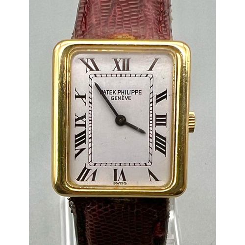 353 - A Classic Patek Philippe 18k Gold Ladies Watch. Burgundy leather strap. 18k gold case - 22 x 25mm. W... 