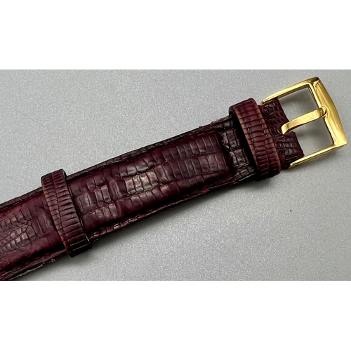 353 - A Classic Patek Philippe 18k Gold Ladies Watch. Burgundy leather strap. 18k gold case - 22 x 25mm. W... 