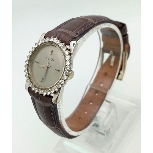 471 - A Jaeger 18k Gold and Diamond Ladies Watch. Grey leather strap. 18k gold case - 23mm. Diamond bezel.... 