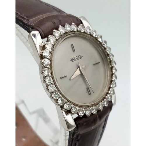 471 - A Jaeger 18k Gold and Diamond Ladies Watch. Grey leather strap. 18k gold case - 23mm. Diamond bezel.... 