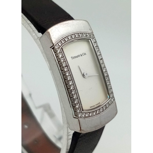 408 - A Tiffany and Co 18K Gold and Diamond Ladies Watch. Black leather strap with Tiffany white gold and ... 