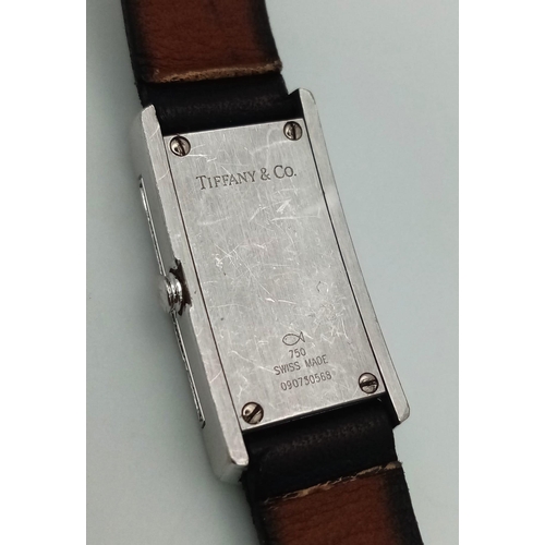 408 - A Tiffany and Co 18K Gold and Diamond Ladies Watch. Black leather strap with Tiffany white gold and ... 