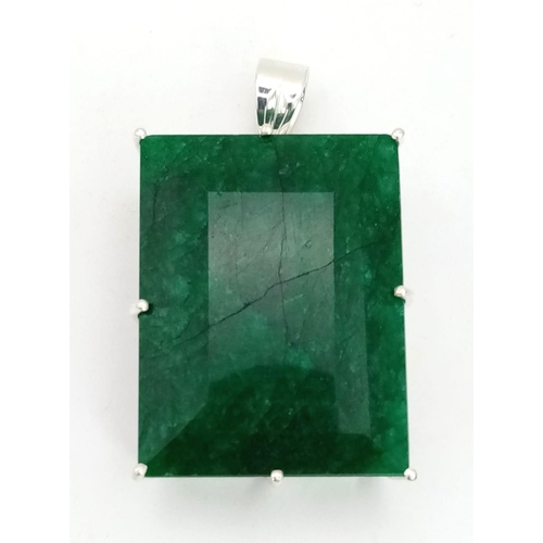 446 - A Huge Emerald Pendant. Rectangular step cut set in 925 Sterling silver. Emerald - 211.30 Ct. 4 x 3.... 