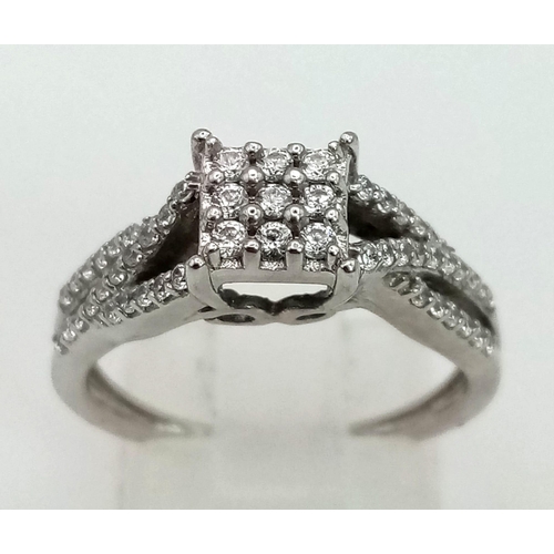 671 - 18k white gold diamond cluster ring (dia: 0.60ct), size N1/2, 4.1g