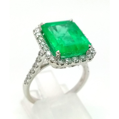 149 - A 950 Platinum 6.19ct Colombian Emerald and Diamond Ring. Octagonal mixed cut emerald with a diamond... 