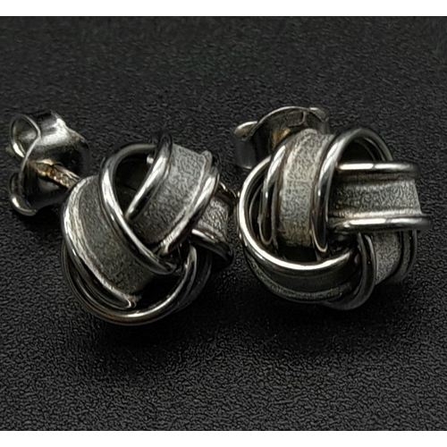 835 - 9k white gold knot earrings. Weighs 3.2g