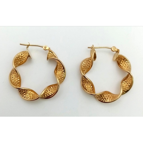 786 - 9k yellow gold twist creole hoop earrings. Weighs1.8g.  2.2cm diameter