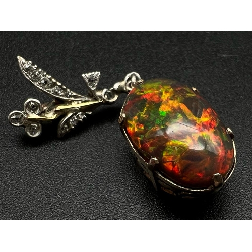 333 - A Vintage high quality vibrant colour black opal - red, green, and fire hints). Estimated 8ct. Set w... 