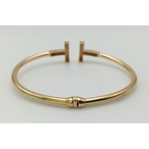 184 - A Stylish 9K Yellow Gold Bangle. Tension extender for comfort. 7g