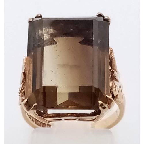 191 - A Vintage 9K Yellow Gold Smoky Quartz Ring. 15ct rectangular smoky quartz on a pierced gold setting.... 