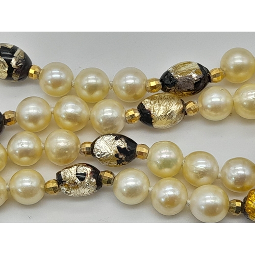 535 - A Cultured Pearl and Murano Glass Necklace. 9K gold clasp. 
40cm.