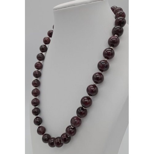 780 - A Garnet Bead Necklace with Silver Clasp. 12mm beads. 44cm.