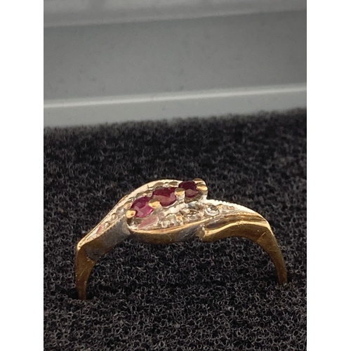 139 - Vintage 9 carat GOLD RING having RED SPINEL and DIAMONDS mounted to top. 1.81 grams.  Size M.