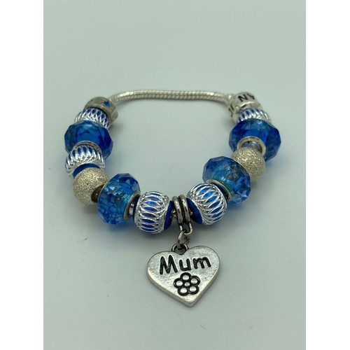 160 - SILVER BRACELET having Silver Sided Blue Charms with clasp marked PANDORA 925 SILVER. To include hea... 